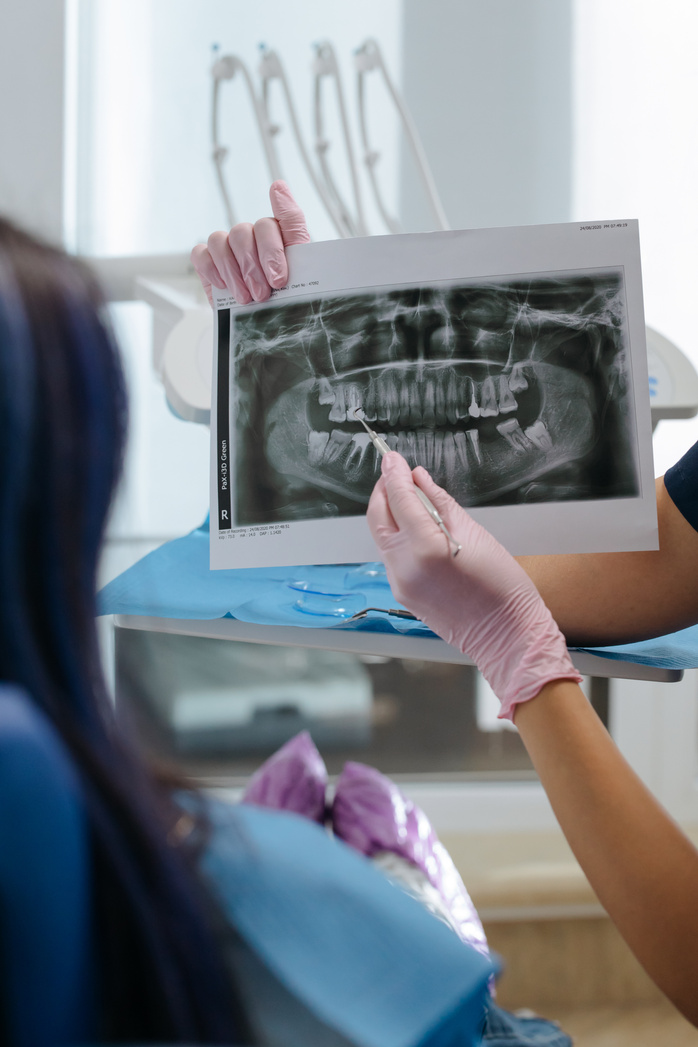 Dentist showing an X-ray Image on a Patient